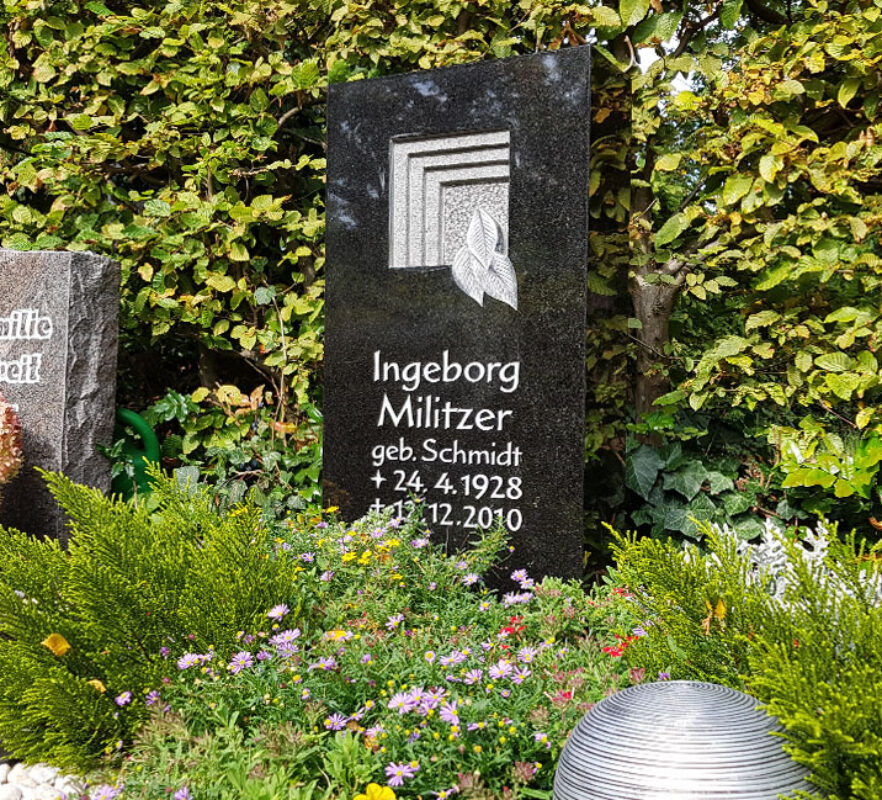 Schwarzer Granit Urnengrabstein mit Grabeinfassung & Grabbepflanzung